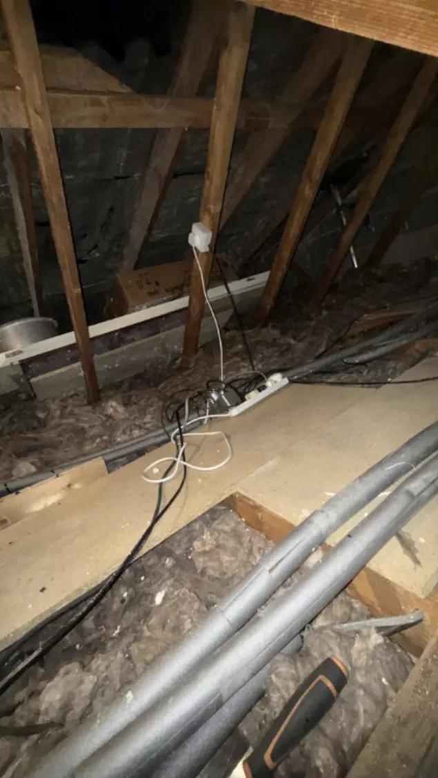 Loft boarded over the insulation with pipework lagged in silver foam